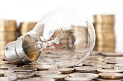 filament-bulb-lying-on-euro-coins