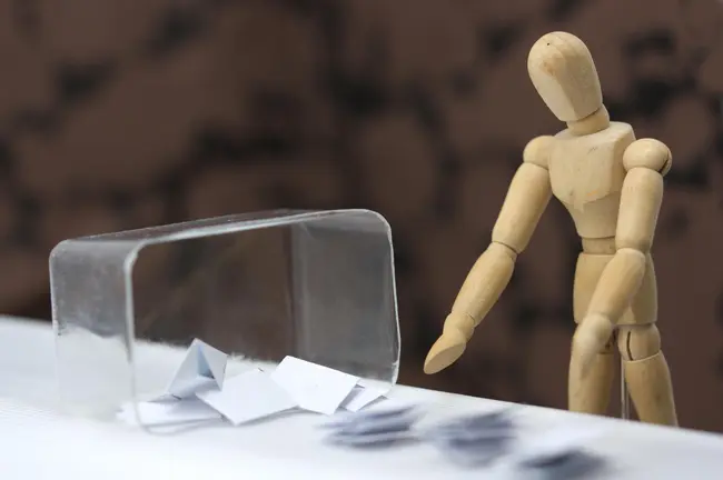 A wooden dummy is taking the votes from the ballot box and counting them