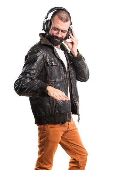 Man wearing a leather jacket listening music