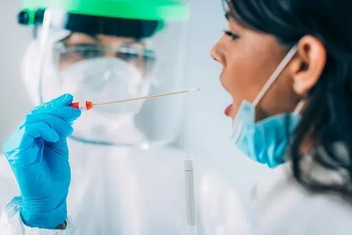 Coronavirus test. Medical worker in protective suite taking a swab for corona virus test, potentially infected young woman