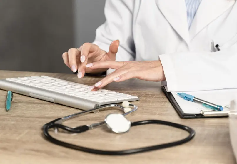 female-physician-at-her-desk-writing-on-keyboard