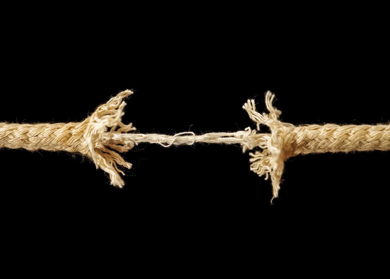 Piece of frayed rope about to break, stress concept