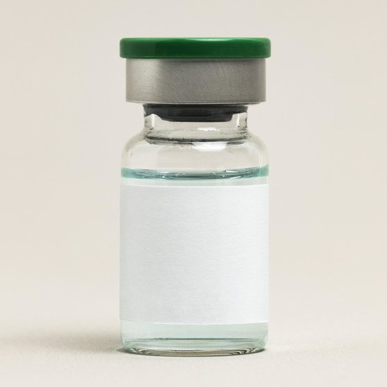 Blank vaccine label on injection glass bottle with green liquid