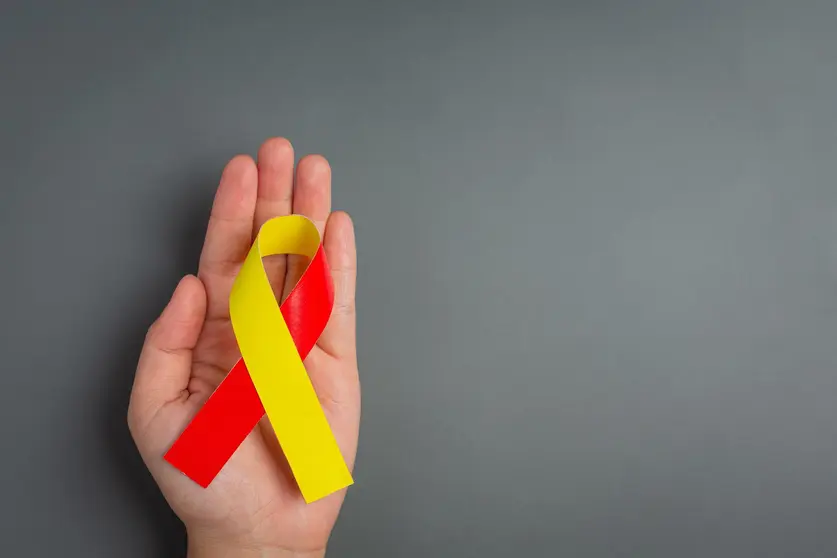 World hepatitis day awareness with red yellow ribbon